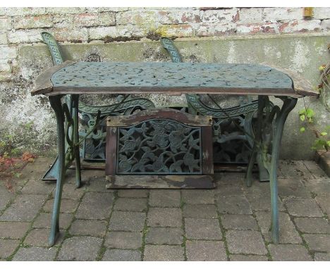 Cast iron table with matching bench and chair back panels, bench ends and chair ends