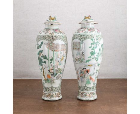 A pair of Chinese famille verte vases,19th century, each elongated body rising to a rounded shoulder and a short straight nec