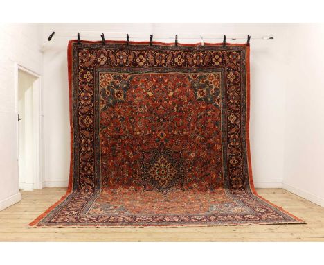 A Mahal carpet,with foliate motifs to a red ground with navy borders,431 x 305cmCondition ReportGood colours and pile through