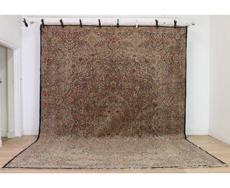 A large Kirman carpet,20th century, with an all-over dense floral design, to a navy border,397 x 306cmCondition ReportEven we