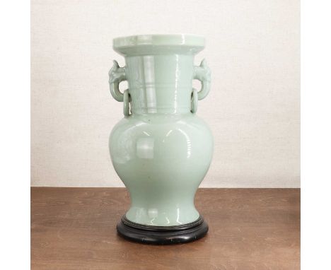 A Chinese celadon-glazed vase,Republic period (1912-1949), of baluster form rising to a ribbed neck, flanked by mask and ring