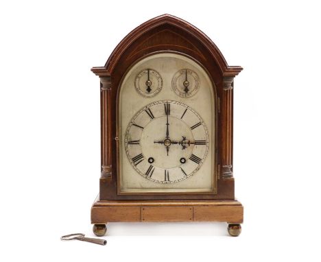 A mahogany mantel clock,early 20th century, with an arched case, the silvered dial with two subsidiary dials, the two train m