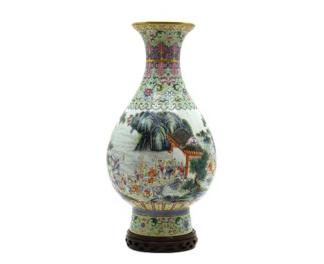 A Chinese famille rose vase,20th century, of pear-shaped form rising from a straight circular foot to a flared mouth, painted