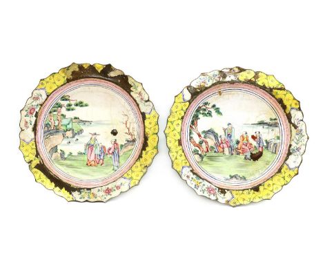 A pair of Chinese enamelled plates, late Qing Dynasty, the circular base rising to an everted rim with lobed edges, painted w