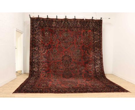 A Mahal carpet,decorated with flower laden vases and foliate motifs, to a red field,434 x 310cmCondition ReportLow pile with 