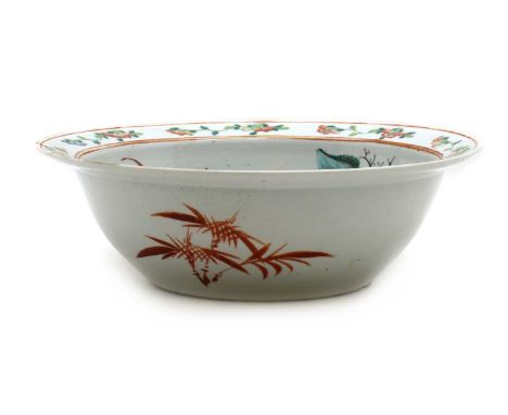 A Chinese famille rose basin,c.1900, the rounded sides rising from a circular foot to a flared mouth, painted with figures in