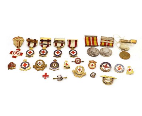 A collection of Red Cross enamel long service medals,a variety of enamel lapel badges' 'Division', 'Detachment', two Long Ser