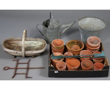 A galvanised-metal watering can &amp; bucket; a wooden trug; &amp; various terracotta flowerpots. 