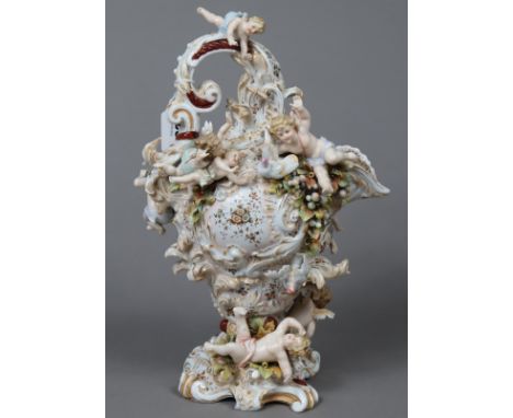 A Dresden-style porcelain ovoid pitcher with all-over floral decoration &amp; adorned with numerous cherub figures, 35cm high