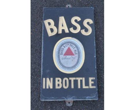 A Bass in Bottle slate brewery sign with oval enamel insert, by Dickson, 11 x 19 3/4".