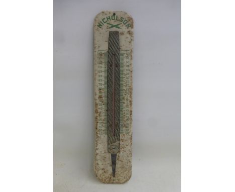 A Nicholson Files pictorial tin thermometer, the thermometer framed by an oversized file, 3 1/4 x 15".