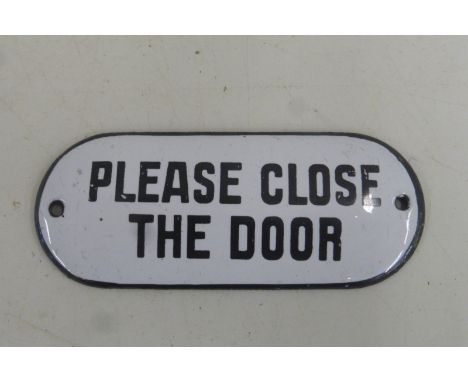 A 'Please close the door' shaped enamel door plate, 4 x 1 3/4".