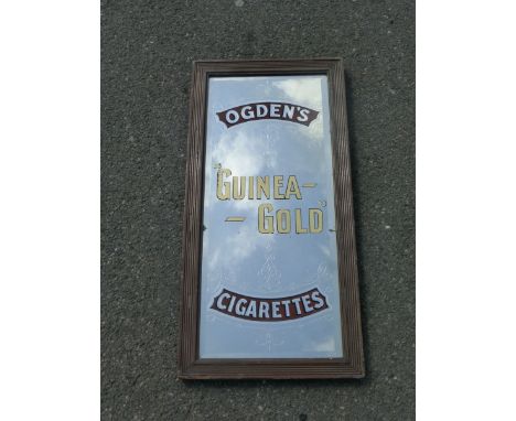 An Ogden's Guinea Gold Cigarettes advertising mirror, 13 1/2 x 27 1/2".