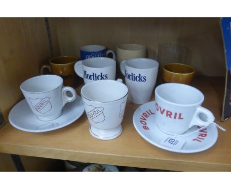 A selection of ceramic mugs each with advertising including five for Bovril, also Horlicks, Ovaltine etc. also an etched glas