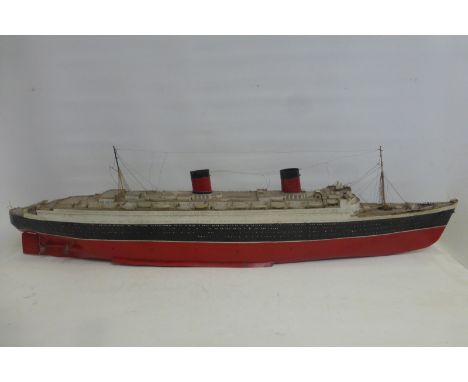 A good quality part tinplate scale model of the Queen Elizabeth ocean liner.