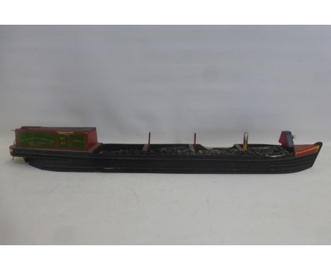 A scale model of a barge carrying a load of coal.