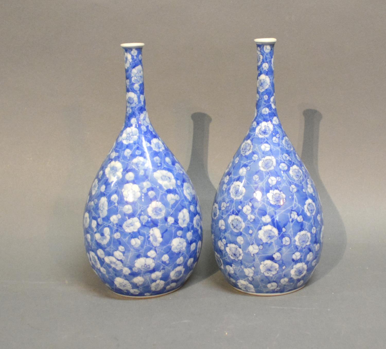 A Pair Of Japanese Under Glazed Blue Decorated Bottle Neck Vases of