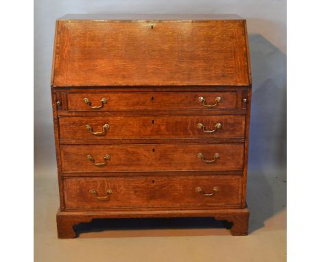 A George III Oak Bureau The Fall Front Enclosing A Fitted Interior above four long graduated drawers with brass swan neck han