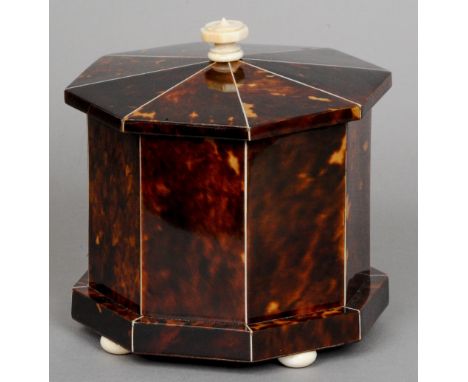 A 19th century ivory mounted tortoiseshell and mahogany tea caddy
Of octagonal form with flattened bun feet.  14.5 cm high. C