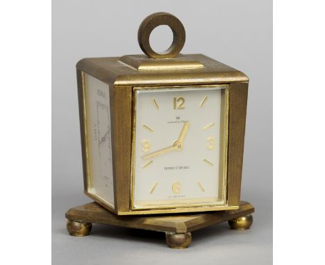 A Hamilton Weathercaster brass cased desk clock
Of rotating square form incorporating timepiece, thermometer, barometer and h