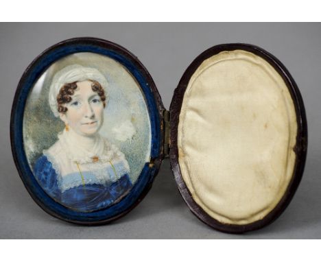 An early 19th century portrait miniature on ivory
Depicting a middle aged woman wearing a lace cap and blue dress, housed in 