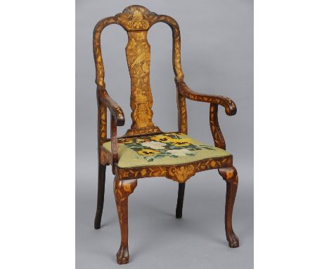 A 19th century Dutch marquetry inlaid open armchair
The shaped top rail above the central back splat over the tapestry  cover