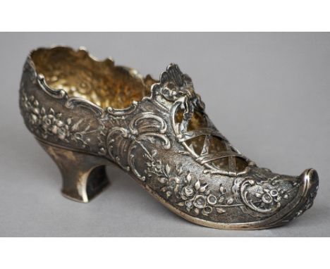 A Dutch silver model of a shoe
With pierced and embossed decoration.  12 cm long. CONDITION REPORTS: Overall good, some gener