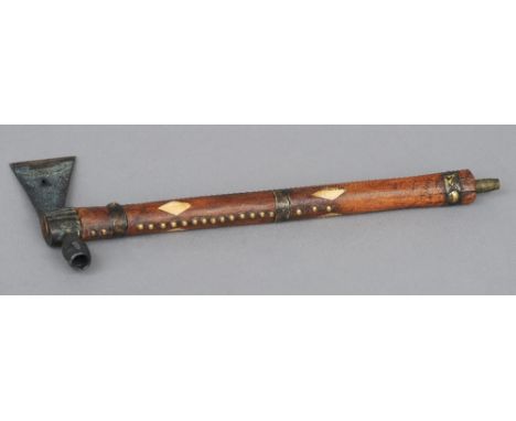An American Indian pipe
The bone inlaid and brass studded shaft with an axe head and pipe bowl.  43 cm long. CONDITION REPORT