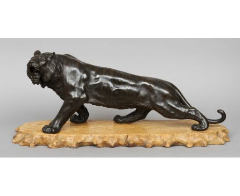 A Japanese Meiji period patinated bronze model of tiger
Naturalistically modelled on all fours, standing on a carved wooden p