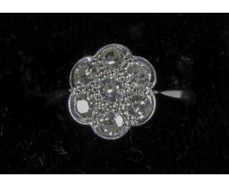 A diamond set 18 ct white gold and platinum daisy ring
In fitted case. CONDITION REPORTS: Generally in good condition, expect