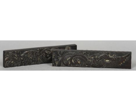 A pair of Chinese carved hardwood scroll weights
One worked with a phoenix, the other with a dragon.  28 cm long.  (2) CONDIT