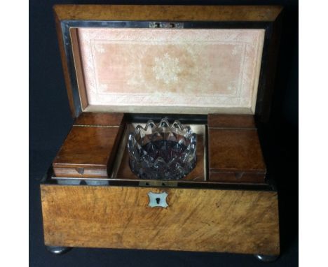 A 19th century burrwood caddy
Of sarcophagus form, the hinged top enclosing a glass mixing bowl flanked with lidded canisters