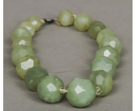 A carved jade necklace
Each graduated bead faceted.  43 cm long overall. CONDITION REPORTS: Generally in good condition, expe