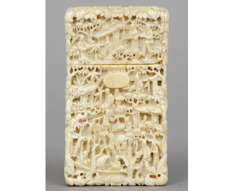 A Chinese Canton carved ivory card case
Profusely worked with figures in various pursuits in a garden landscape.  10 cm high.