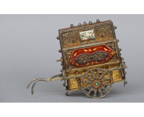 A white and gilt metal enamel decorated and semi-precious stone set model of a street organ, stamped 925
Enclosing a musical 