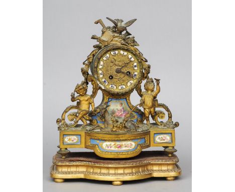 A 19th century gilt metal and Sevres type porcelain inset mantel clock
The repousse dial headed with musical trophies and fla