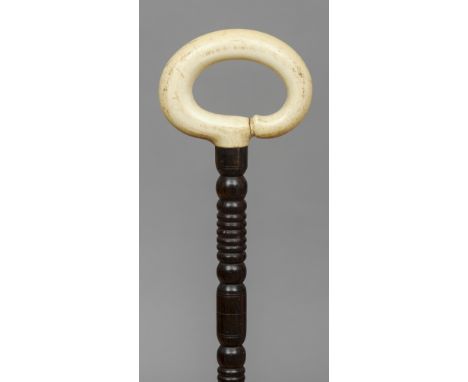 A 19th century ivory handled rosewood walking stick 
The ivory loop handle above the turned shaft with an ivory ferrule.  86.