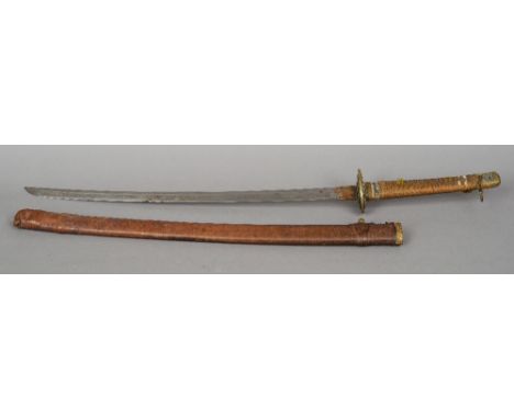 A Japanese officers sword
Of typical form with bound shagreen hilt and leather scabbard.  88 cm long overall. CONDITION REPOR