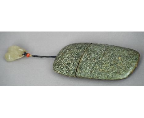 A Chinese shagreen spectacle case 
With carved jade toggle worked as a pair of fruit and enclosing a pair of tortoiseshell ri
