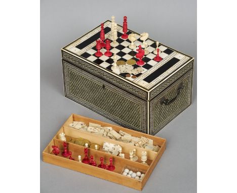 A 19th century Anglo-Indian ivory and ebony inlaid games compendium
The rectangular hinged top inlaid with a chessboard flank