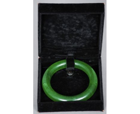 A Chinese carved spinach jade bangle
Boxed.  8.5 cm diameter. CONDITION REPORTS: Generally in good condition, expected wear, 