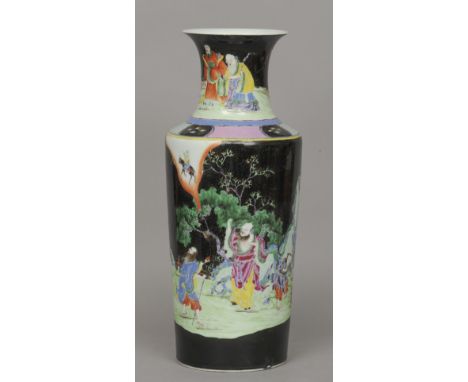 A Chinese famille noir vase
Decorated with figures in a continuous garden landscape.  46 cm high. CONDITION REPORTS: Crack to