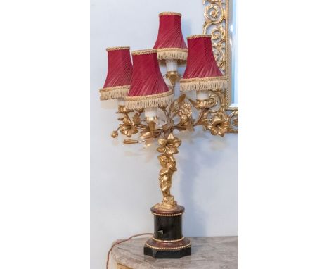 A pair of early to mid 20th century French four branched candlesticks, converted for electricity, Cherub columns on stepped b