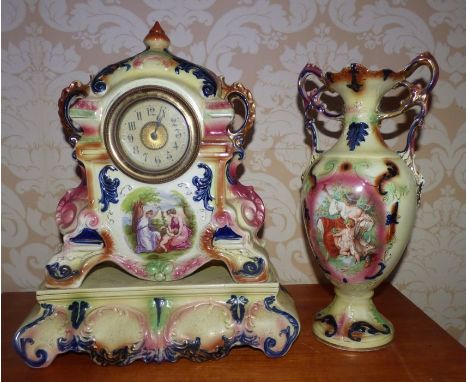 Ceramic clock on a stand with a matching vase , decorated with printed scenes of maidens in classical costumes , 45 cm high .