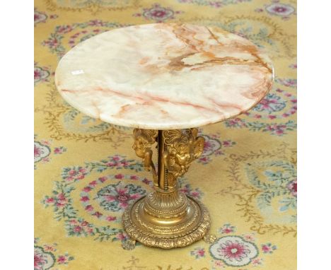 A late 19th century side table, onyx circular top raised on ornate cherub brass stand, raised on three paw feet 46cm H x 50cm