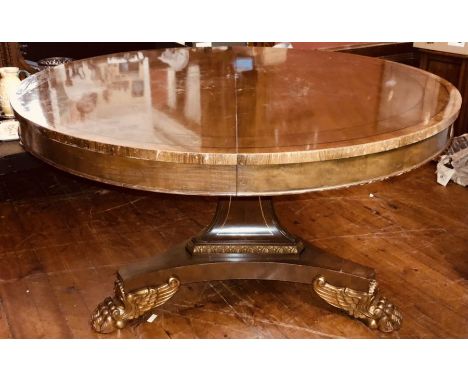 A Regency revival mahogany and gilt wood extending breakfast table by Baker Furniture, circular extending top with turned fol