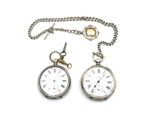 Two swiss silver hallmarked cased pocket watches, both with machine turned decoration and vacant shield escutcheons on the re