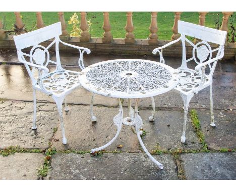 A selection of cast metal painted garden furniture, a cast iron circular table with four cast aluminium chairs and along with