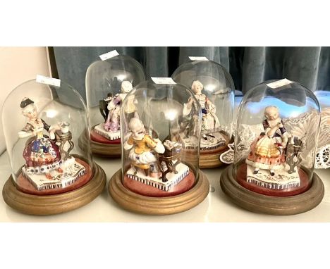 Five 20th century ceramic musician figures, all on wooden bases with glass domes (5)Please note this item is at an offsite lo