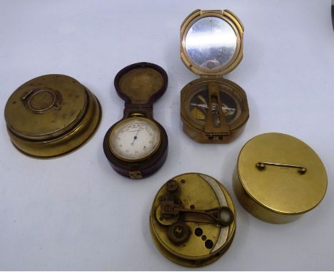 A brass pocket barometer in a leather case , a brass compass , a brass navigation item and a brass ink pot (4)